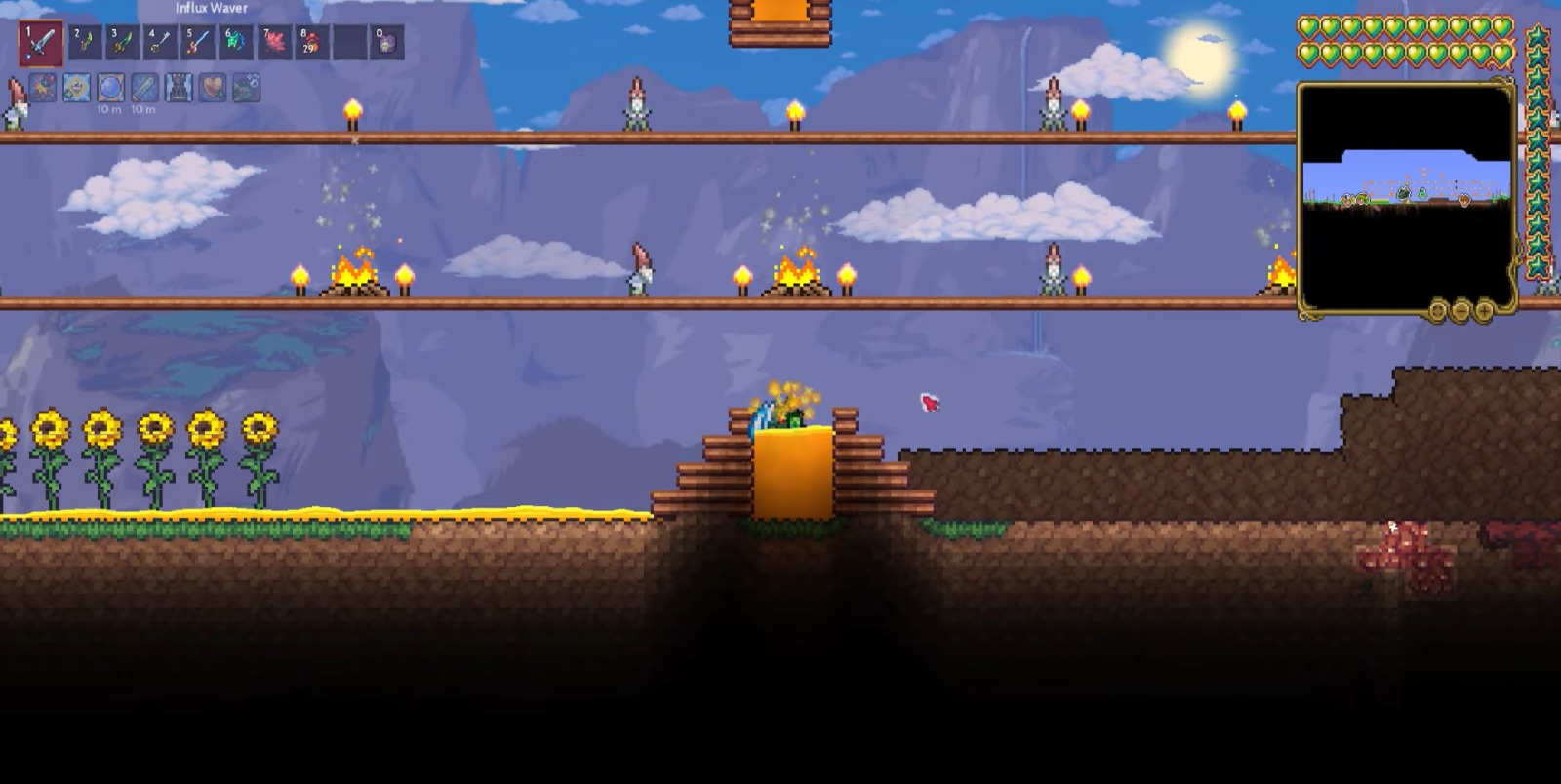 A player’s character in 'Terraria' standing on a platform adorned with sunflowers and torches under a daytime sky.