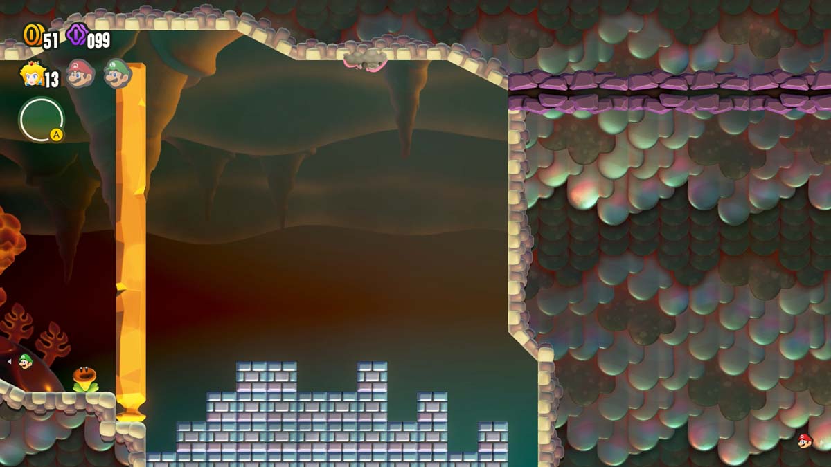 A silhouette of the iconic Super Mario landscape is formed with bricks in a subterranean cave with a glowing orange backdrop.